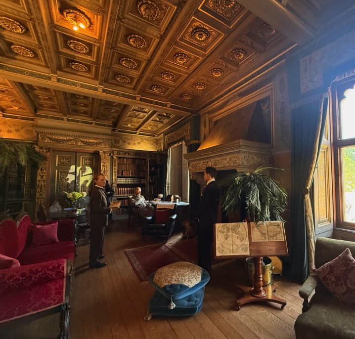 A panelled room at Warwick Castle furnished and set with costumed period figures