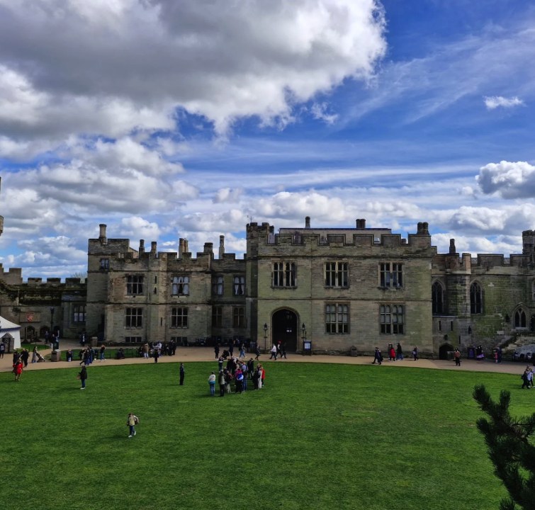 The courtyard lawn at Warwick Castle with the Great Hall range behind it