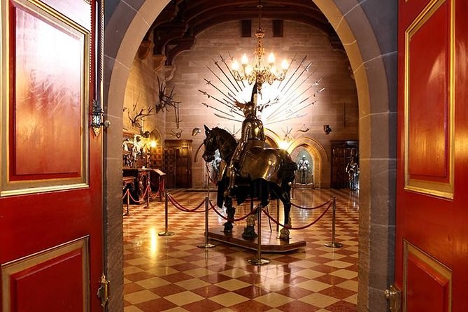 An armoured horse and rider framed in the red doorway to the Great Hall